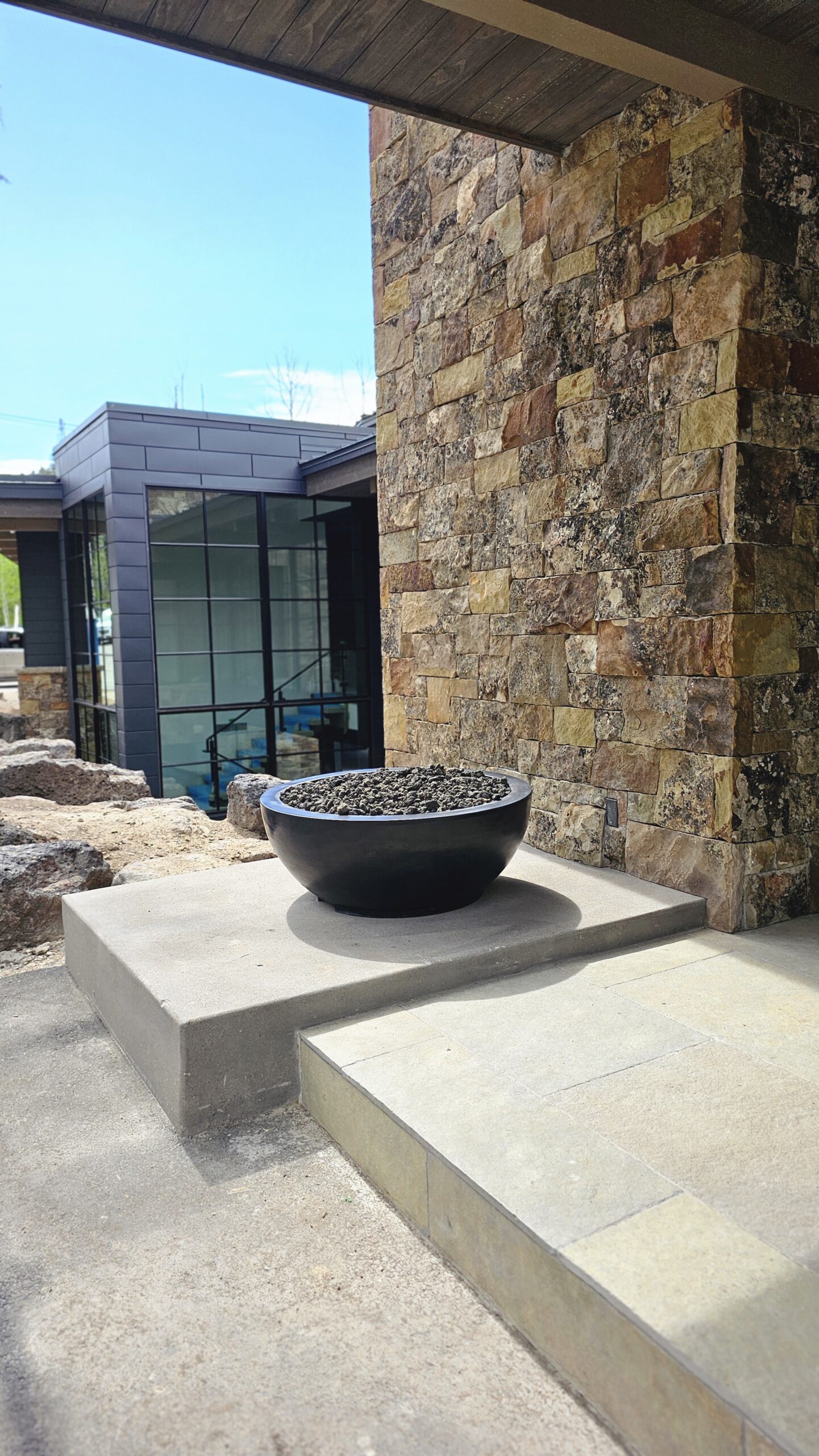 Round fire bowl as poolside centerpiece